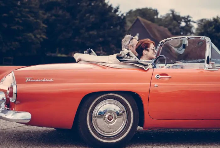 Couple Riding Red Ford Thunderbird during Daytime &middot; Free ...